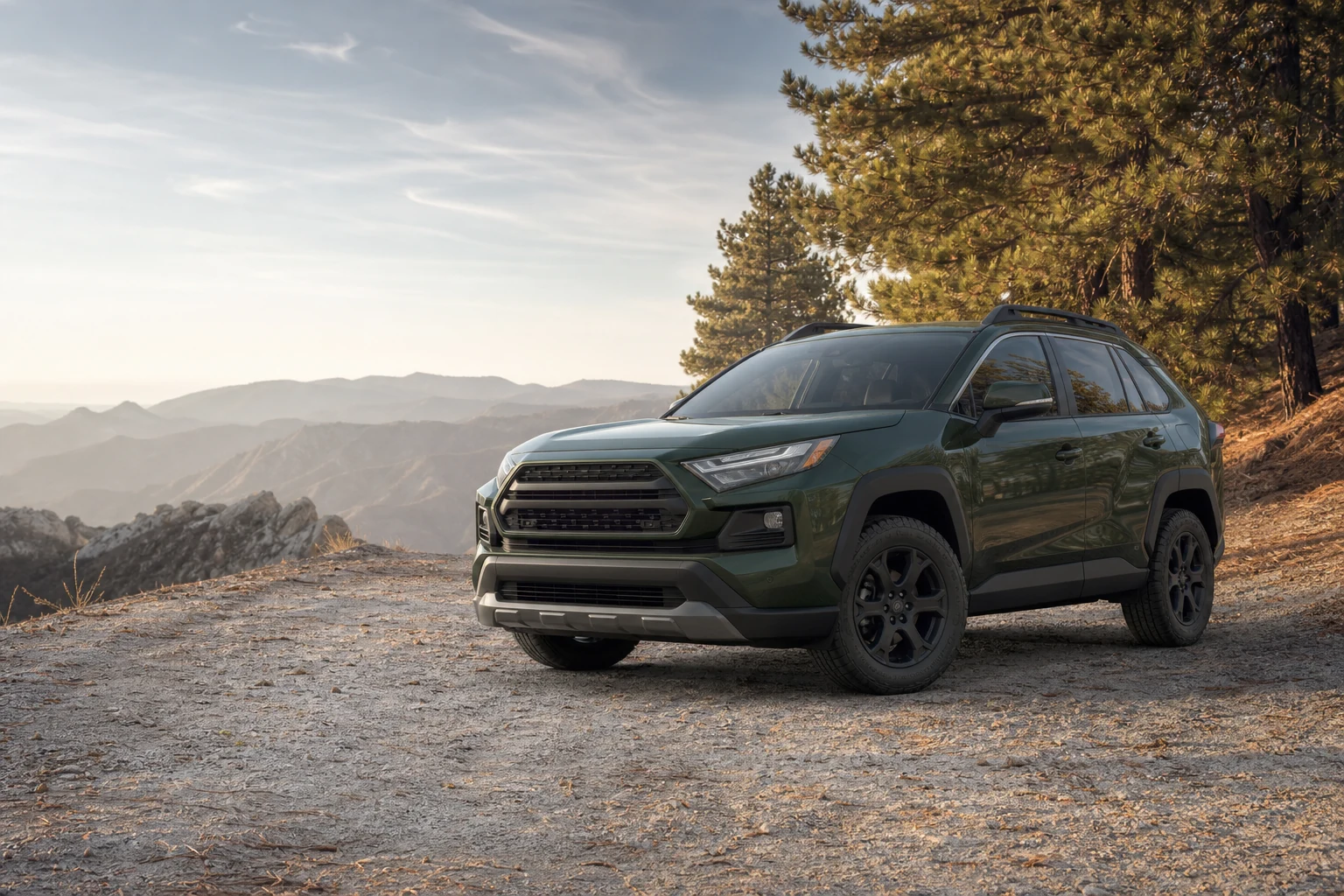 Unbadged compact SUV on a highland trail representing the Toyota RAV4 vehicle class